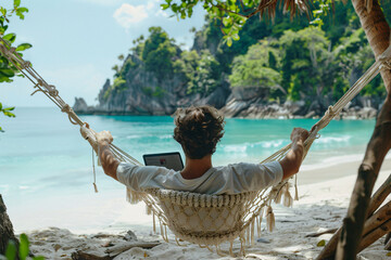 Young man relaxing in a hammock with his laptop overlooking a picturesque beach, embodying the digital nomad lifestyle