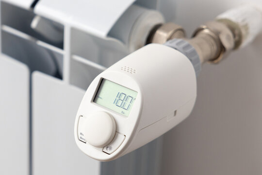 White heating battery and electronic, smart temperature regulator. warmth in the room and the house. preparation for spring and winter. energy saving