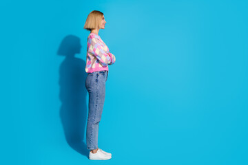 Photo portrait of pretty young girl profile empty space folded hands confident wear trendy pink outfit isolated on blue color background