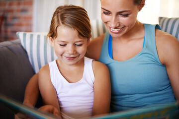 Home, book and mother with kid, girl or hobby with smile or bonding together in a living room....