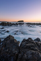 Morning view of Stack Island from the rocky coastline of Minnamurra, Australia.