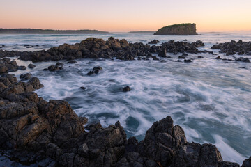 Morning view of Stack Island from the rocky coastline of Minnamurra, Australia.