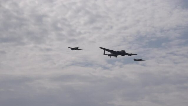 Avro Lancaster bomber world war 2 plane spitfire and Hawker Hunter in formation in the sky. Flying close to camera England UK 4K