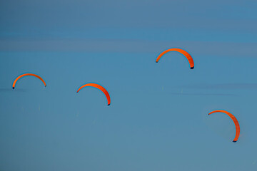 Parachutes in the blue sky on a winter day