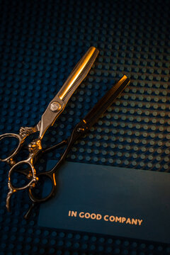 Barber scissors lie on a blue background