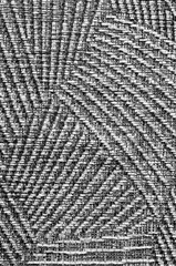 The texture of the fabric. Close-up of a gray fabric made from various thick threads. black and white photography
