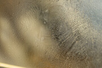 close shot of sandpaper on glass for frosted effect