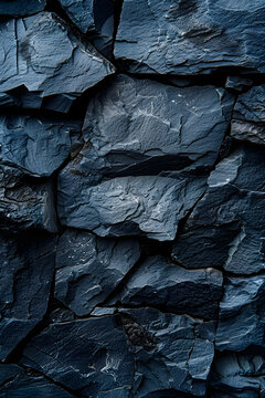 A close up of a bedrock grey stone wall with an electric blue pattern, resembling an intrusion on the outcrop. It has a textured surface similar to wood flooring