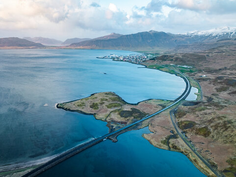 Aerial view of coastal village with mountain range and blue water bay, Grundarfjardarbaer, Western Region, Iceland.