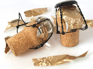 two champagne corks over white background