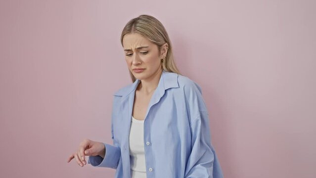 Fearful young blonde woman's disgusted reaction! wearing shirt, hands over face with disgust, displeased, aversion in full swing. isolated on pink background. portrait of a displeased beauty.