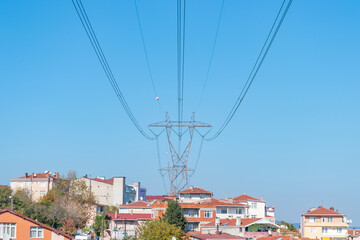 Obraz premium Electric poles and lines at or high voltage towers at isolated sky. A clear sky view from below the lamppost.