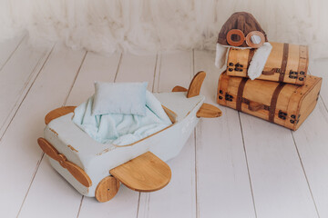 a little airplane for a newborn baby in a photo studio - obrazy, fototapety, plakaty
