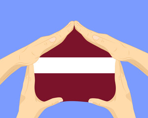Obraz premium Hand home with Latvia flag, residential or investment idea, housing and home concept