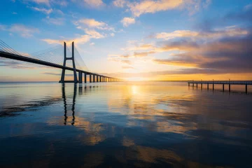 Selbstklebende Fototapeten Vasco da Gama bridge and pier over tagus river in Lisbon (Portugal), at sunrise © p_rocha