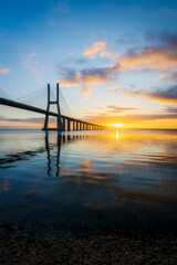 Fototapeta na wymiar Vasco da Gama bridge over tagus river in Lisbon (Portugal), at sunrise