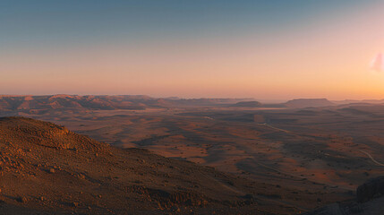 Fototapeta na wymiar A panoramic view of a desert landscape at twilight with long shadows and soft pastel colors.