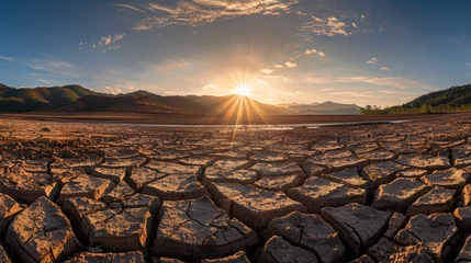 Zelfklevend Fotobehang A parched cracked earth landscape under a scorching sun illustrating severe drought conditions. © Finsch