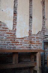 loft style red brick wall with wood bench