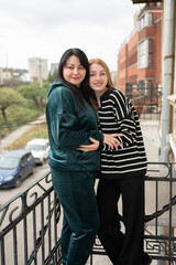 Two women standing on the balcony	