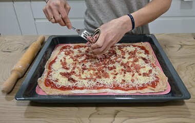 Making pizza, adding tuna