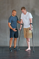 Physical therapy, crutches and patient with disability to exercise at clinic for recovery, strength...