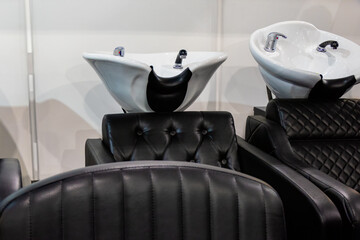 Hair wash sink and beauty salon chair. This is a professional and functional space for providing hair care services.
