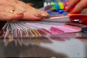 Samples of nail polish of different colors and shades applied to the tester plate. The stand featured many different shades of nail polish, showing shoppers a wide range of options.