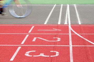 Bicycle moving fast on a tartan running track like a flash