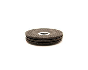 Stack of brand new aluminum oxide general purpose griding wheels, manufactured with heat treated grit grains in high concentrations cutting steel and ferrous metals, stone, isolated background