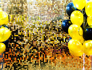 Background of small multi-colored shiny tiles. There are balloons on the sides. The tiles are laid in rows creating a visually appealing design. Gold and black foil tiles.