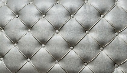 White leather upholstery. Close-up texture of genuine leather with white rhombic stitching. Luxury background. White leather texture with buttons for pattern and background