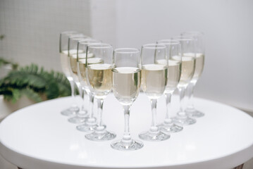 row of champagne glasses on buffet table