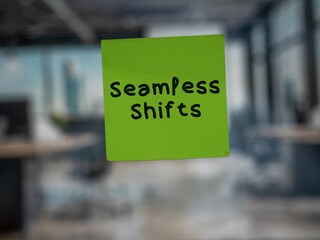 Post note on glass with 'Seamless Shifts'.