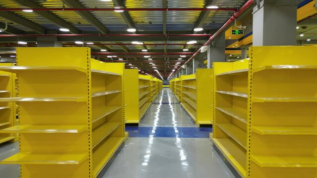 Empty yellow shelves of the big market or a factory