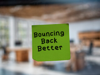 Post note on glass with 'Bouncing Back Better'.