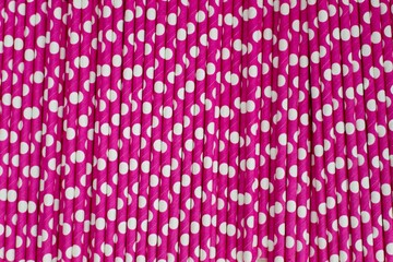 Abstract image of pink straws with white polka-dots