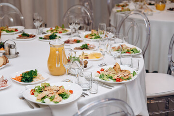 banquet table with plates of caesar salad
