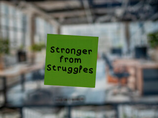 Post note on glass with 'Stronger from Struggles'.