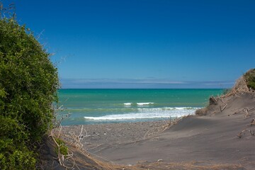 Idyllic beach featuring picturesque white sand, clear blue providing a tranquil atmosphere