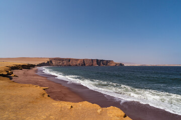 red beach coastline with storming weather in Peru