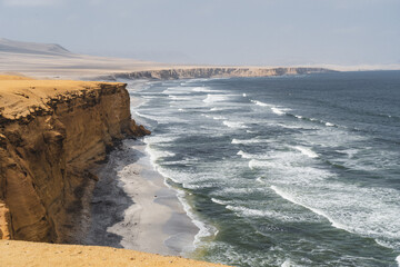 waves crashing on rocks at the coast of Peru