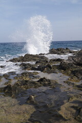 onda che si schianta sulle rocce della costa, scogli, con schizzi, spruzzi d'acqua che si...