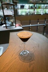 espresso martini cocktail at beautiful wooden bar