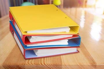 Many bright colored office folders on desk