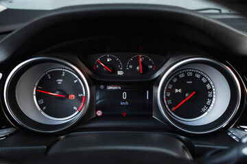 Stylish, spacious family car. Modern car interior, black perforated leather, aluminum, details controls, leather steering wheel.