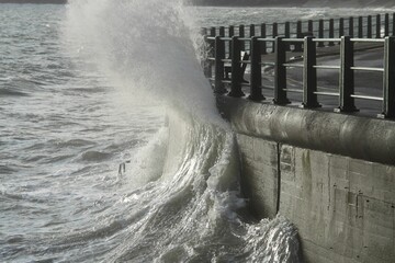 Sea waves crashing against the pier wall