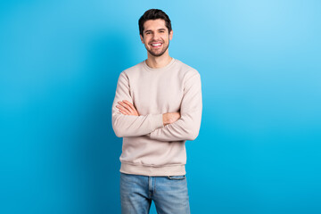 Photo of satisfied handsome man with stylish haircut dressed beige pullover standing arms crossed...