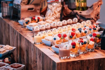 Array of colorful fruit pastries scattered around the wooden table