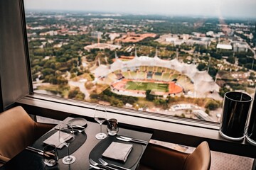 Cafe table in front of a window with a scenic view of a stadium in the background